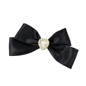 Elegant black satin bow hair clip with a large heart-shaped rhinestone and pearl trim