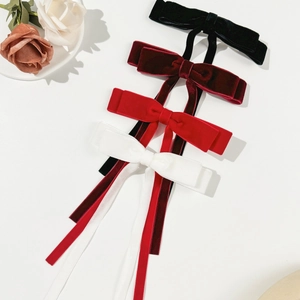 Detailed display of long velvet bow hair clips in black, burgundy, red and white colors