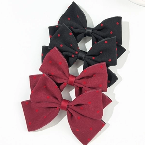 Set of four French style polka dot bow hair clips in elegant black and burgundy red