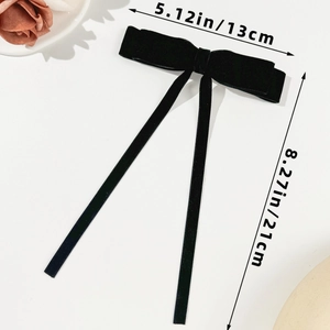 Detail showing dimensions of the black velvet bow hair clip, 13cm width by 21cm length