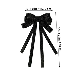 Detailed size view of black velvet bow hair clip with gold silk glitter and long ribbons