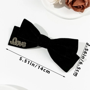 Detailed view of black velvet bow hair clip with Love letter and dimensions 14cm x 6.5cm