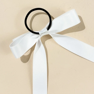 Close-up detail of smooth white satin ribbon bow with high-elastic black hair tie