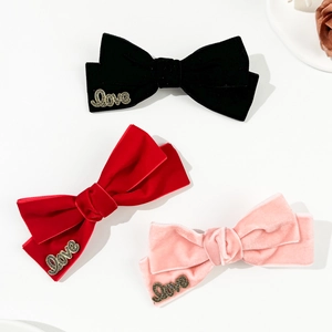 Three-piece velvet bow hair clips in black, red, and pink with metal Love charms