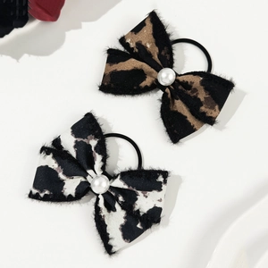Leopard and cow print bow hair ties with faux pearl detail for elegant ponytail styling