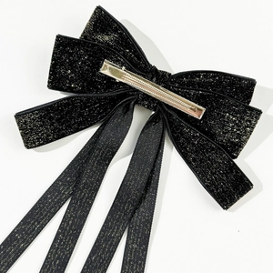 Detail view of the silver metal duckbill clip on the black velvet bow hair accessory