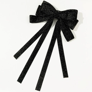 Elegant black velvet hair clip with sparkling gold glitter bow and long flowing streamers