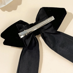 Detailed back view of a black velvet bow hair clip with a silver metal alligator clip