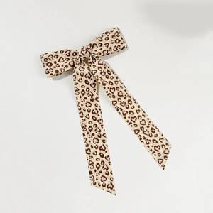 Leopard print heart pattern hair bow with long ribbons on a white background
