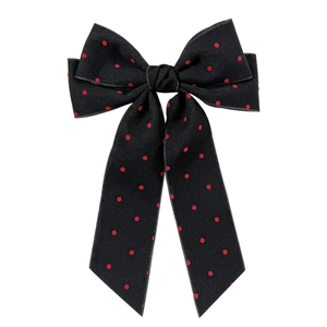 Elegant black bow hair clip with red polka dots and long ribbons on a white background
