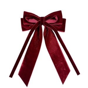 Elegant deep red velvet bow hair clip with long flowing streamers in vintage style