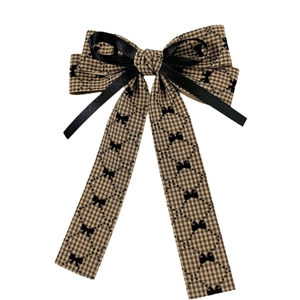 Houndstooth bow hair clip with black ribbon patterns and long streamers on white background