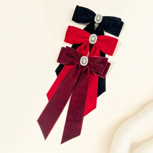 Elegant velvet bow hair clips in black and red with sparkling central rhinestones