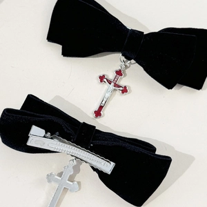 Detailed view of gothic velvet bow hair clip with red cross pendant and metal duckbill clip