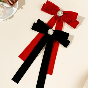 Elegant velvet bow hair clip with central pearl sunflower detail and long streamers