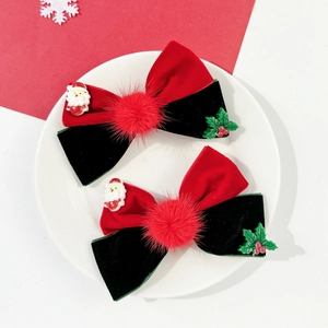 Detail of red velvet Christmas bow clips with mini Santa and holly leaf decorations