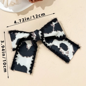 Detailed view of leopard bow hair clip with plush edges and dimensions 12cm by 10cm