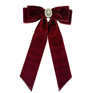 Elegant burgundy velvet bow hair clip with a sparkling crystal centerpiece for women