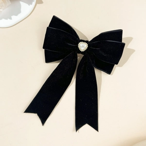 Elegant black velvet bow hair clip with a gold-rimmed heart pearl for women