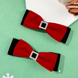 Detail of red and black velvet Christmas bow hair clips with sparkling rhinestone centers