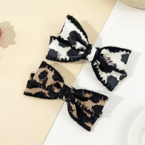 Leopard and cow print bow hair clips with feathered edges for autumn and winter fashion