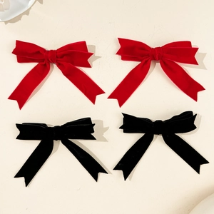 Elegant velvet bow hair clips in red and black colors with a vintage layered ribbon design