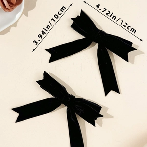 Detail view of 12cm velvet bow hair clips with specific dimensions and material texture