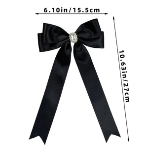 Detailed view of large black satin bow hair clip with crystal showing 27cm length dimension
