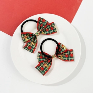Détail de nœuds de Noël rouges et verts avec motifs de rennes dorés et ruban