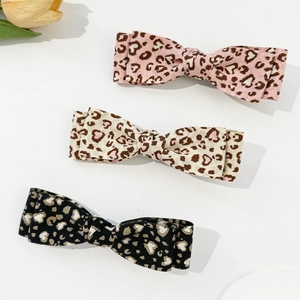 Three-piece leopard print bow hair clips set in pink, beige, and black colors