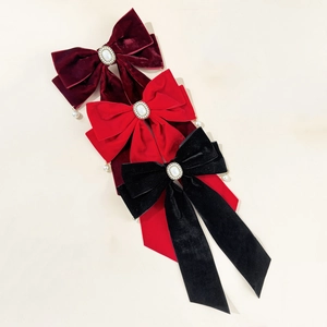 Velvet bow hair clips in red and black with elegant pearl and rhinestone details
