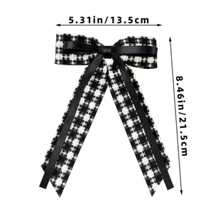 Detail showing the 13.5cm width and 21.5cm length of the houndstooth bow hair clip