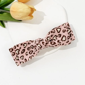 Close-up of pink leopard heart print fabric bow hair clip with premium stitching