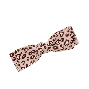 Pink leopard print bow hair clip with heart patterns and soft fabric texture