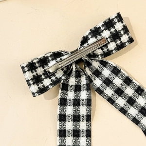 Detailed back view of houndstooth bow hair clip with sturdy silver metal duckbill fastener