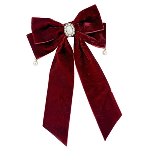 Elegant red velvet bow hair clip with large pearl gemstone for festive hair styling