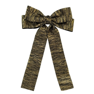 Detail of large metallic gold and black pleated bow hair clip with elegant long ribbons