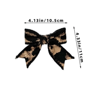 Detail view of leopard print bow hair clip with dimensions 10.5cm width and 11cm height