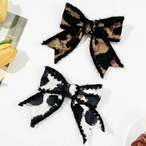French vintage leopard and cow print bow hair clips with soft fuzzy texture edges