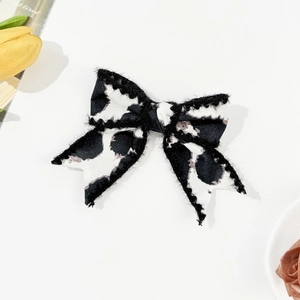 Vintage leopard print bow hair clip with black faux fur trim on a clean white background