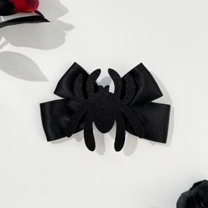 Gothic black spider bow hair clip for Halloween with dark rose decorative background