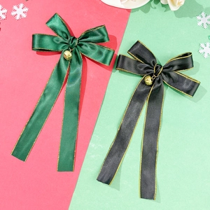 Christmas bow hair clips in green and black satin with gold trim and tiny bells