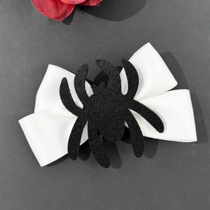 Gothic Halloween hair clip featuring a white satin bow and black velvet spider decoration
