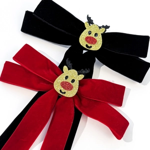 Weihnachtliche Haarschleifen aus Samt mit goldenen Rentier-Motiven in Rot und Schwarz