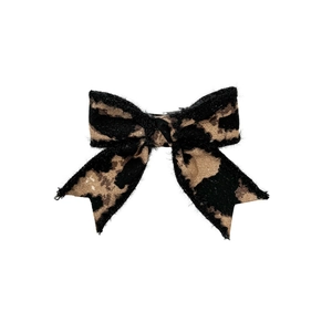 French vintage leopard print bow hair clip made of textured woven fabric on white background
