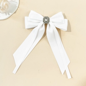 Elegant white satin ribbon bow hair clip with a central sparkling round rhinestone decoration