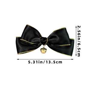 Detail view of a black satin hair bow with gold edges and size dimensions 13.5x6.5cm