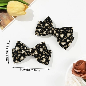Detailed view of leopard print bow hair clips with specific dimensions 10cm by 6cm