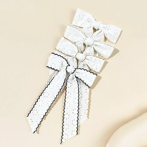 Elegant white lace bow hair clip set with intricate floral embroidery and ribbon detail