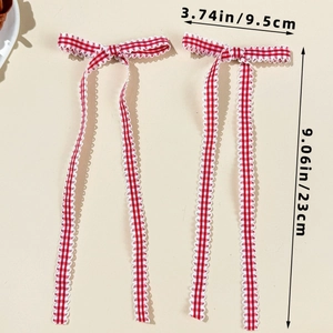 Detail view showing dimensions of red checkered ribbon bows with long streamers